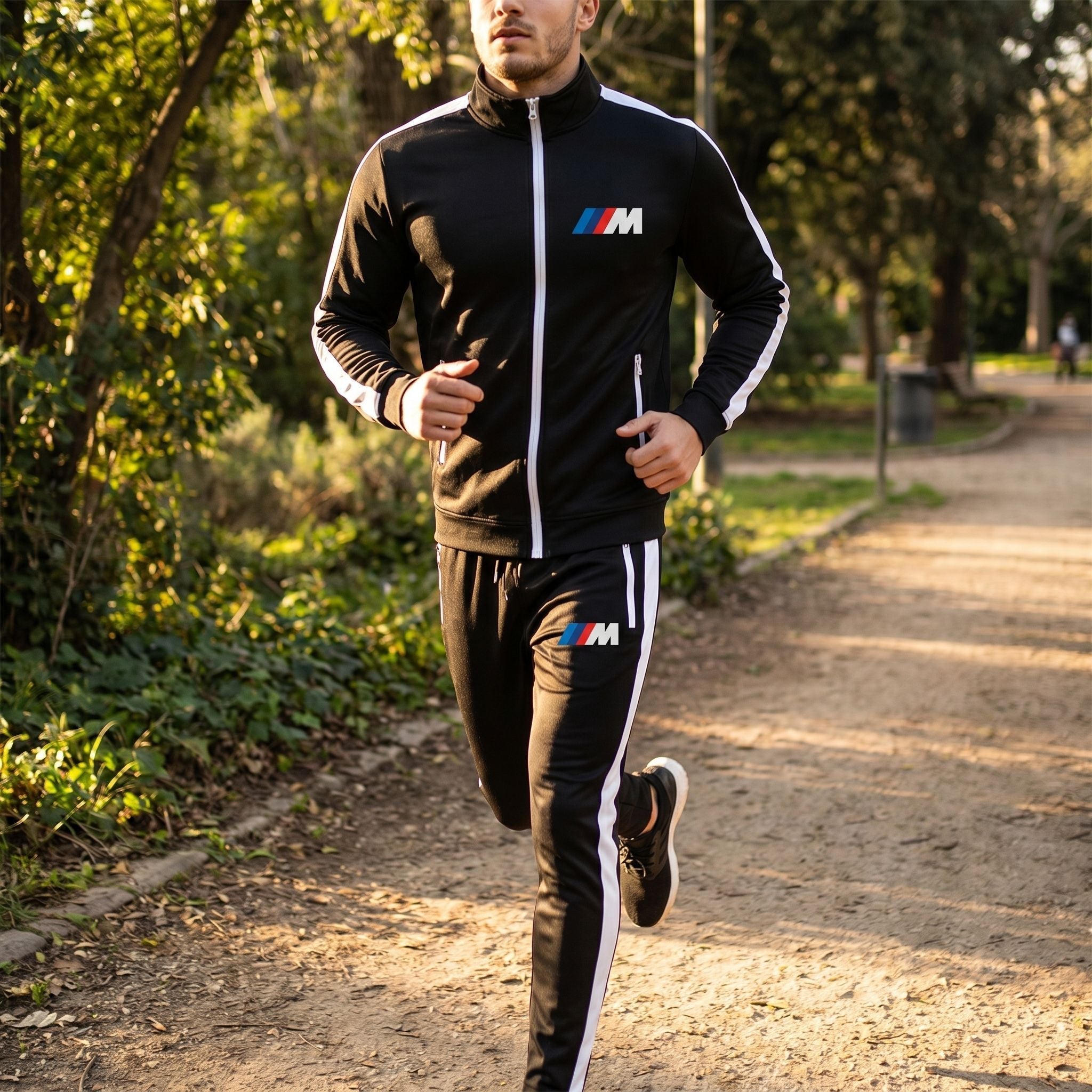 Male model jogging in BMW M Dri-Fit Track Suit along park path during late afternoon, showing breathability and outdoor versatility.